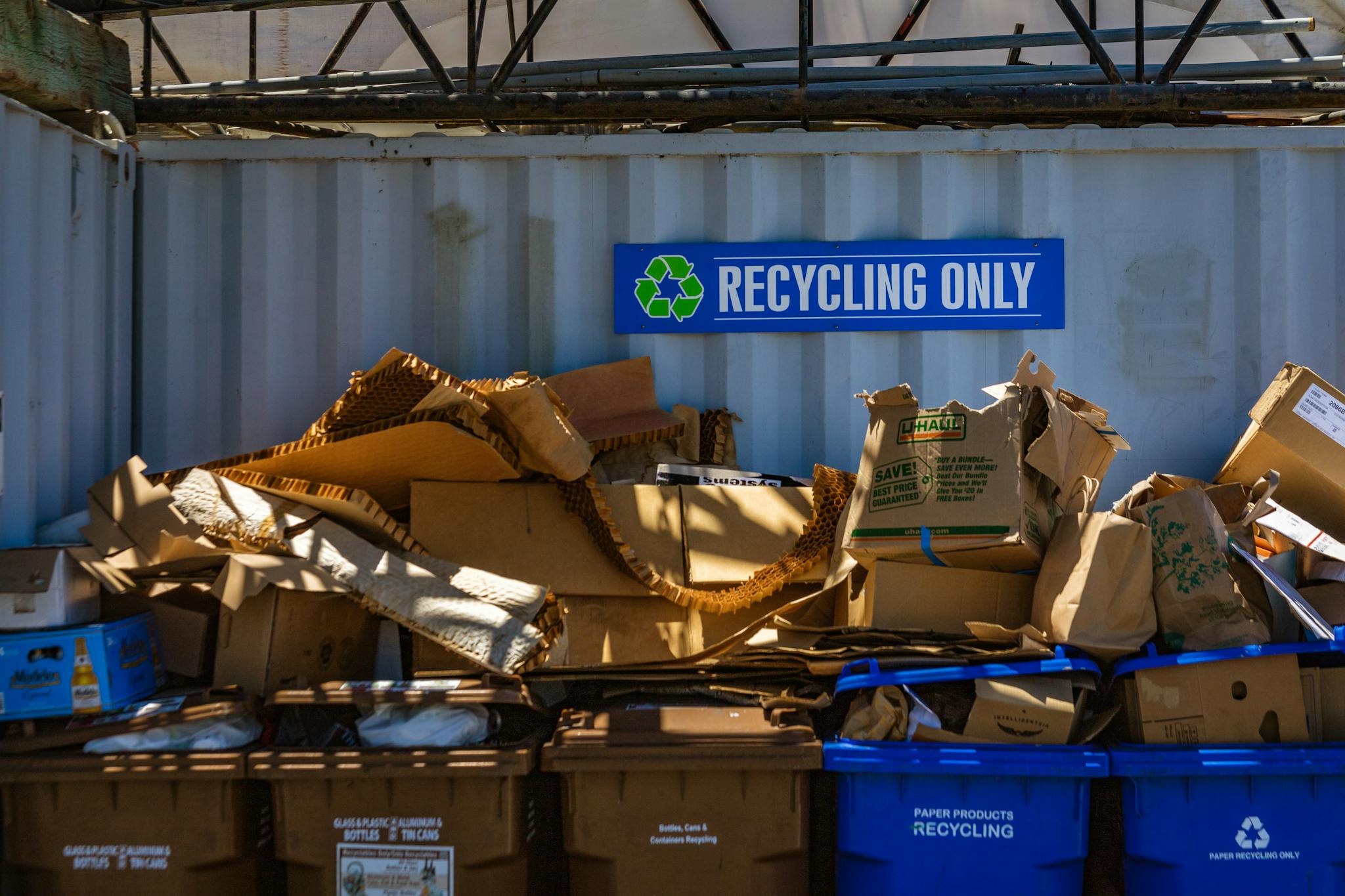 Recycling area filled with cardboard and paper materials, promoting sustainability.